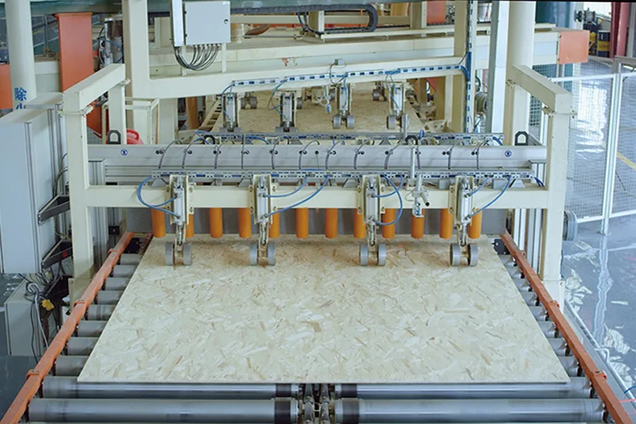 Automated pick head with vacuum and pin grippers lifting a board off a conveyor at a Ningfeng plant